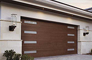 A Faux Wood, Low-Maintenance Garage Door with Modern Planks and Windows