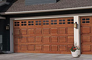 A Natural Wood Garage Door with Classic Short Panel Design with Divided Lite Windows
